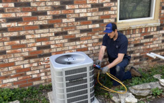 Donovan & Jorgenson Heating and Cooling technician doing AC repair in Mukwonago, WI