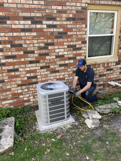 Donovan & Jorgenson Heating and Cooling technician doing AC repair in Mukwonago, WI