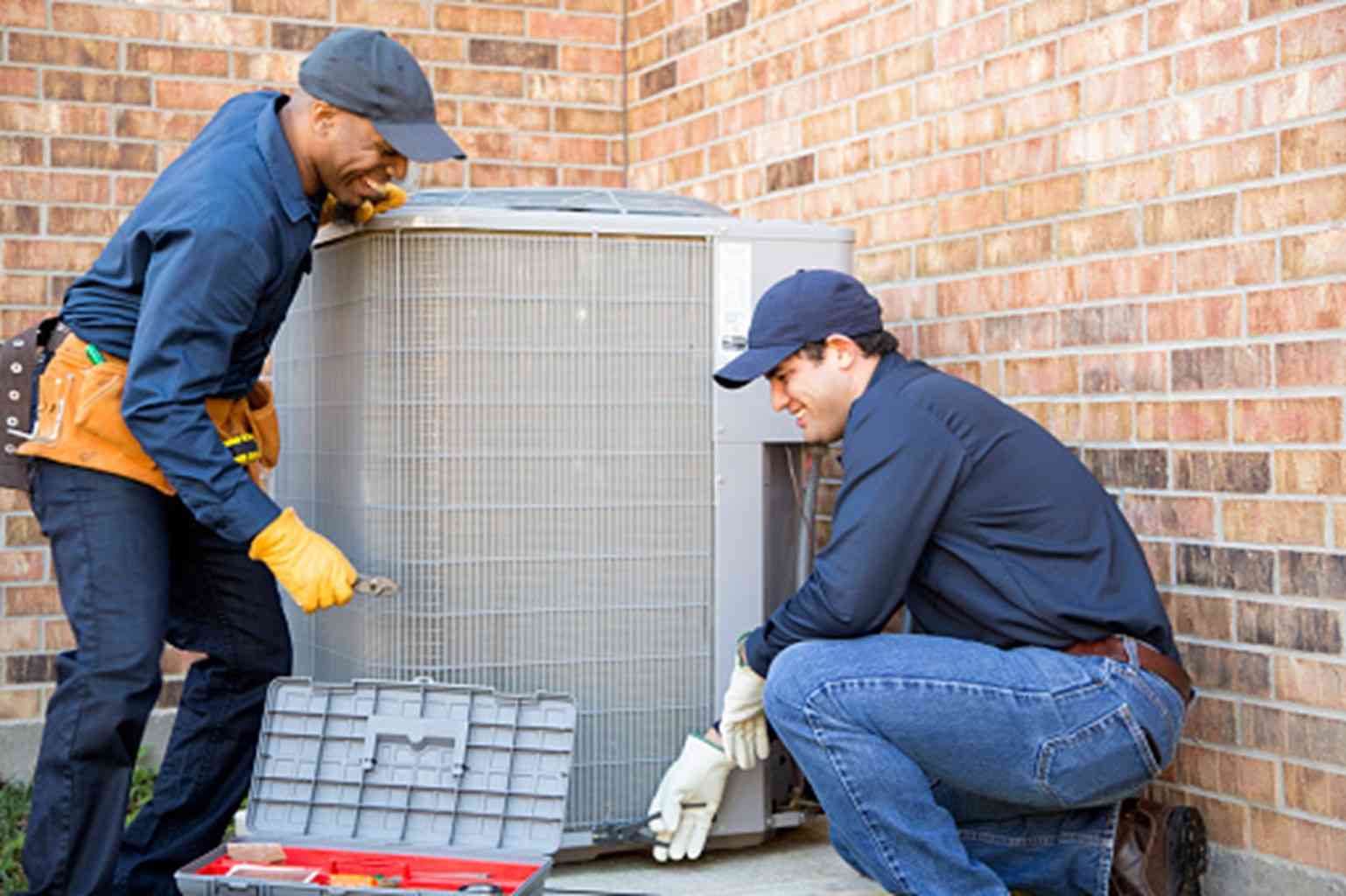 HVAC technician working on a heating system by Donovan & Jorgenson Heating and Cooling