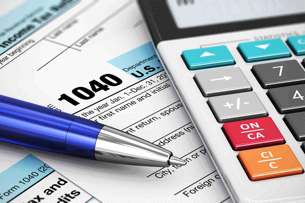 Pen and calculator on a desk by Donovan & Jorgenson Heating and Cooling in Mukwonago, WI