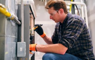 Technician repairing a furnace system in Mukwonago, WI