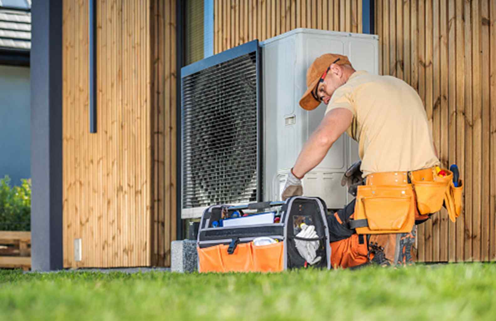 Technician Performing Outdoor HVAC System Maintenance and Repair in Mukwonago, WI